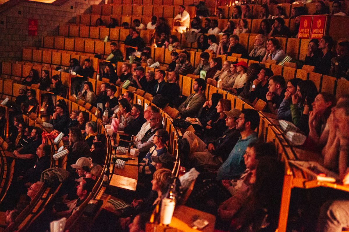 A full auditorium of Movie Sprint guests waiting for the screening to start