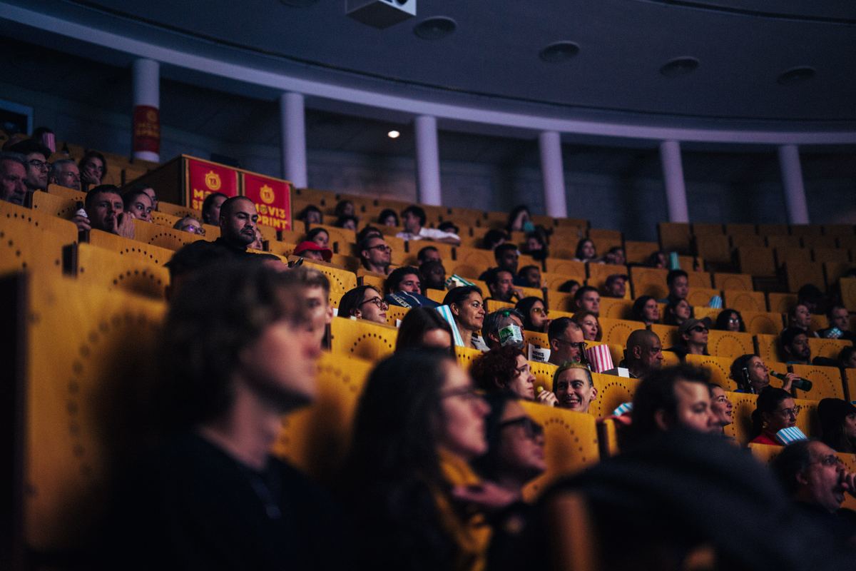 Movie Sprint guests watching a film, faces lit by the screen