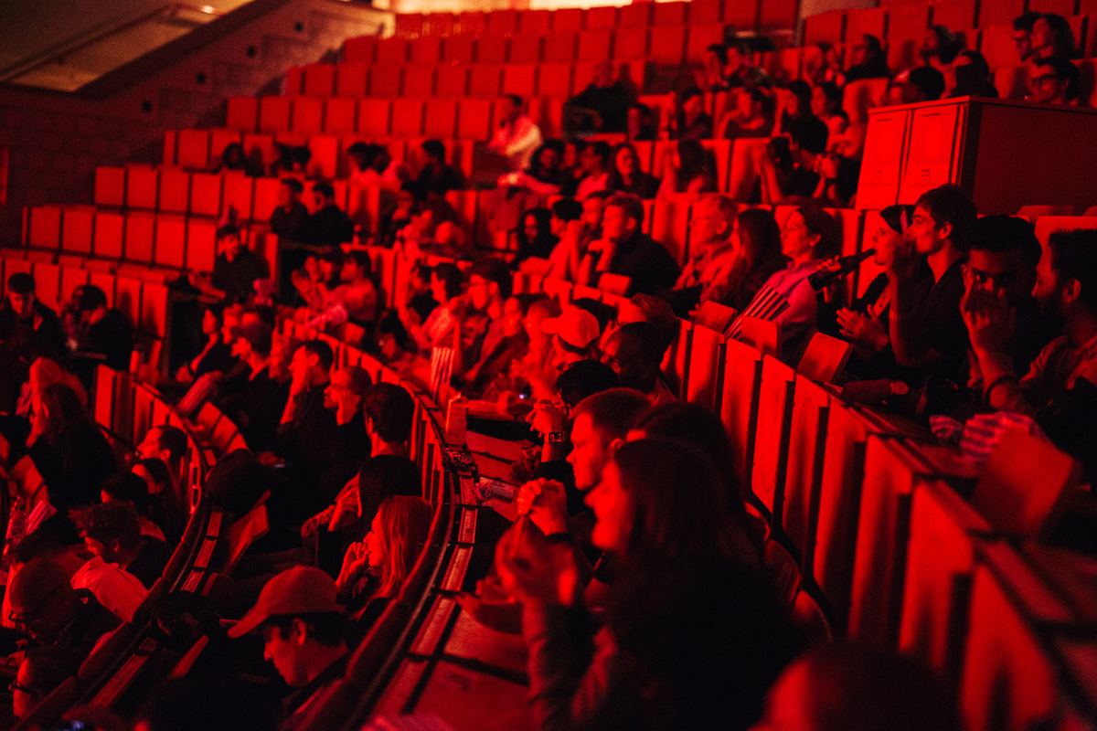 A Movie Sprint audience in a cinema lit deep red